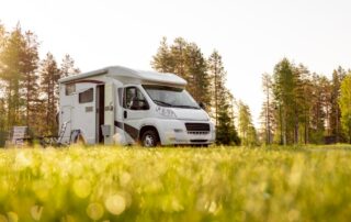 Small RV with lawn chairs